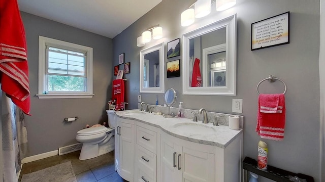 bathroom with tile patterned flooring, vanity, and toilet