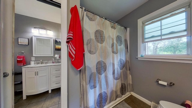 full bathroom featuring toilet, shower / bath combination with curtain, vanity, and tile patterned floors