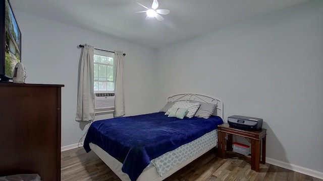 bedroom featuring ceiling fan and dark hardwood / wood-style floors