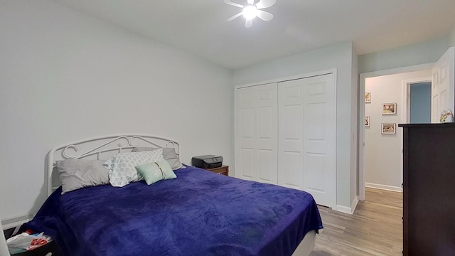 bedroom with hardwood / wood-style floors, a closet, and ceiling fan