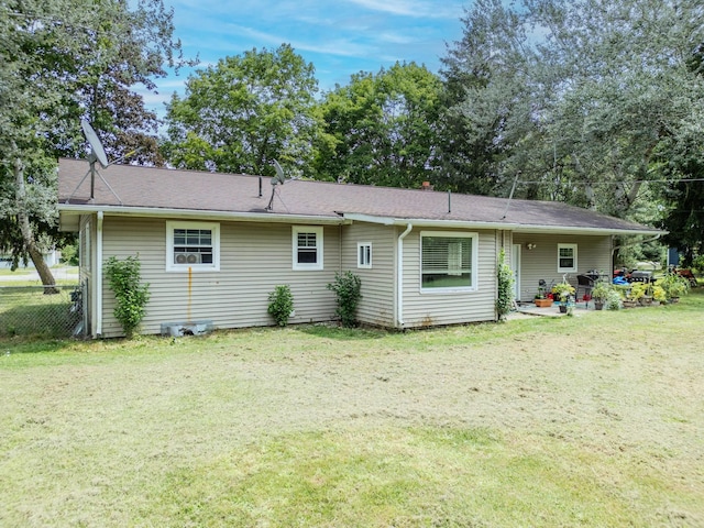 back of house with a lawn