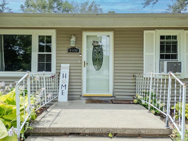 property entrance featuring cooling unit and a porch