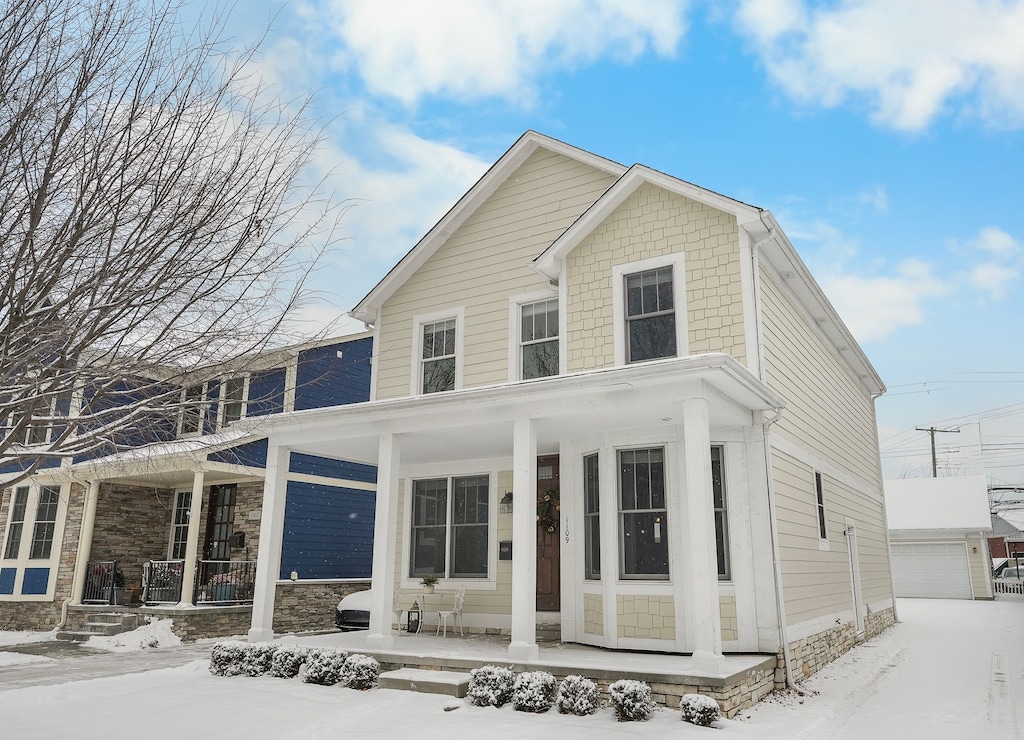 view of front of property featuring an outbuilding, covered porch, and a garage