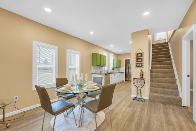 dining room featuring sink and light hardwood / wood-style flooring