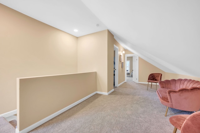 living area featuring lofted ceiling and light colored carpet