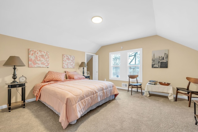 bedroom featuring lofted ceiling and light carpet