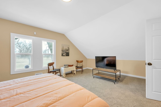 bedroom with carpet flooring and vaulted ceiling