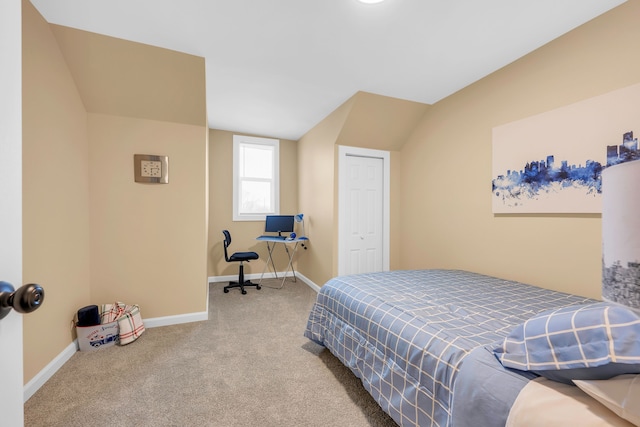 bedroom with lofted ceiling and carpet flooring