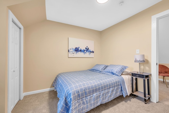 carpeted bedroom featuring vaulted ceiling