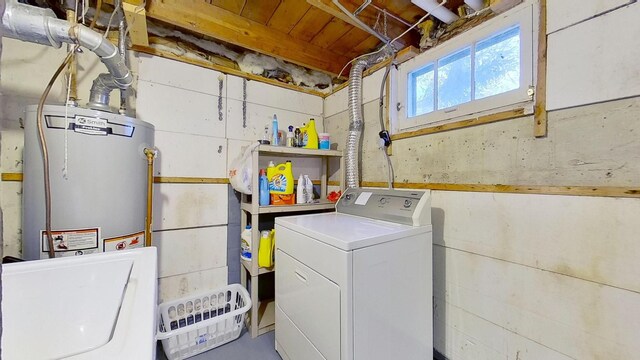 clothes washing area featuring washer / dryer and water heater