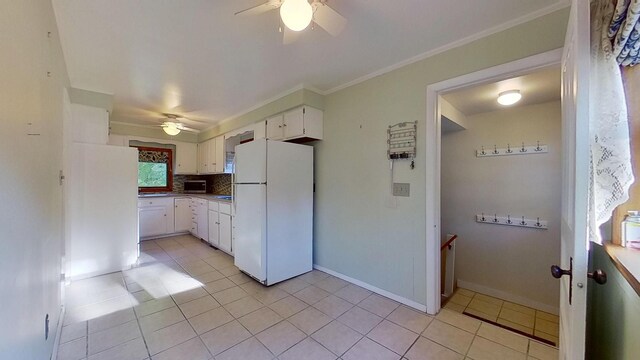 kitchen featuring tasteful backsplash, white cabinetry, white fridge, light tile patterned floors, and ceiling fan