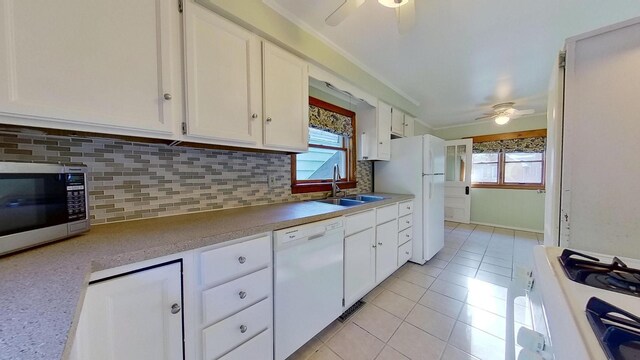 kitchen featuring white cabinetry, sink, white appliances, and decorative backsplash