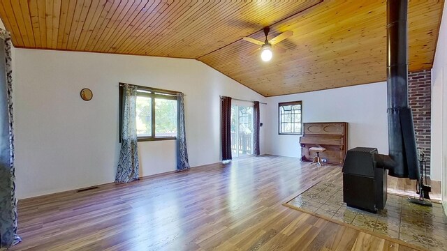 living room featuring ceiling fan, a healthy amount of sunlight, wooden ceiling, and light wood-type flooring