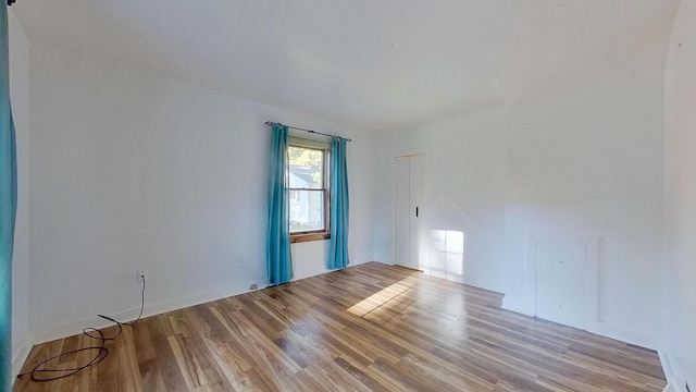 spare room with light hardwood / wood-style flooring