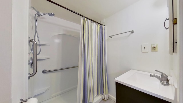 bathroom featuring vanity and curtained shower