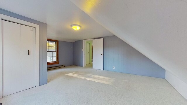 bonus room featuring lofted ceiling, light colored carpet, and baseboard heating