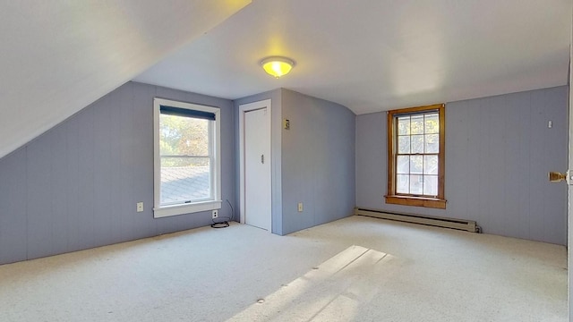 bonus room featuring a baseboard radiator, vaulted ceiling, and light carpet