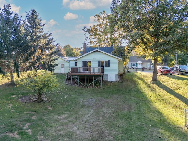 back of property with a yard and a deck