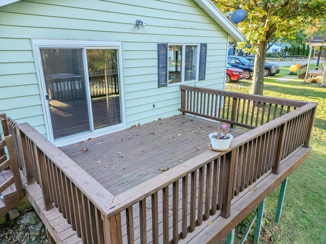 wooden deck with a lawn