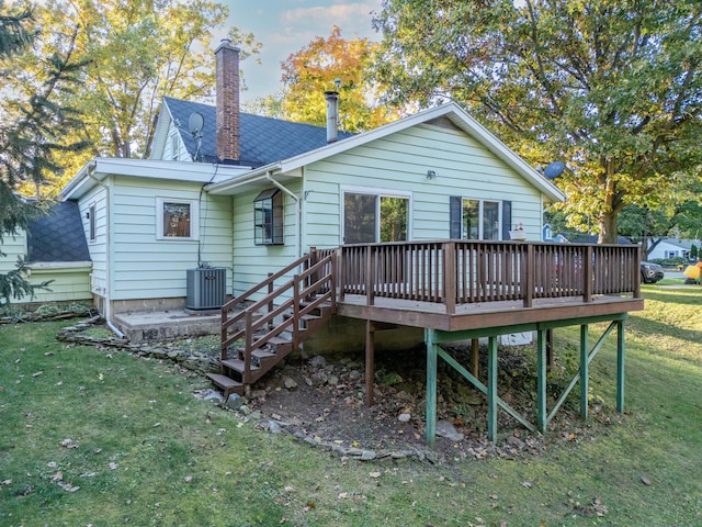 back of property with central AC unit, a yard, and a deck