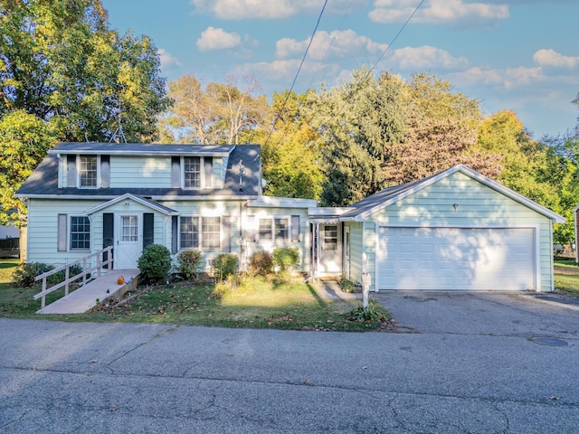 view of front of house featuring a garage and a front lawn