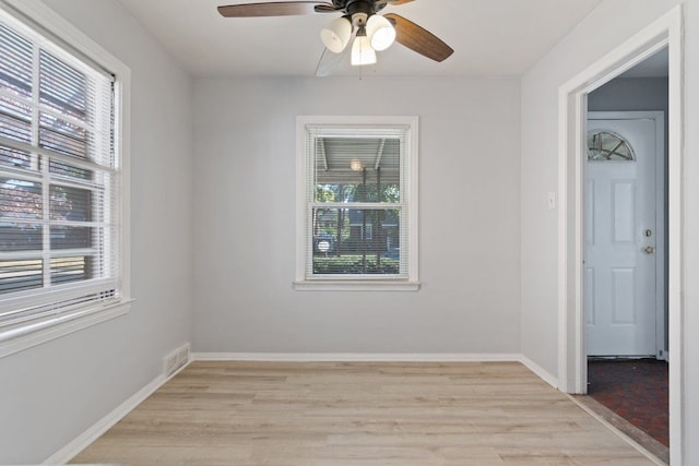 unfurnished room with light hardwood / wood-style flooring, plenty of natural light, and ceiling fan