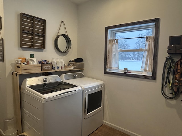 clothes washing area with dark hardwood / wood-style flooring and washer and clothes dryer