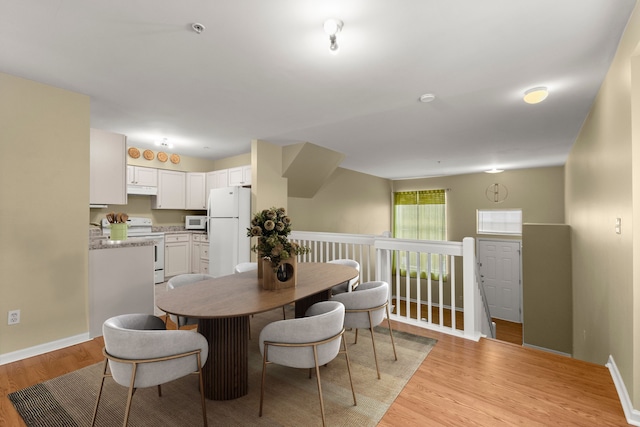 dining room with light hardwood / wood-style floors