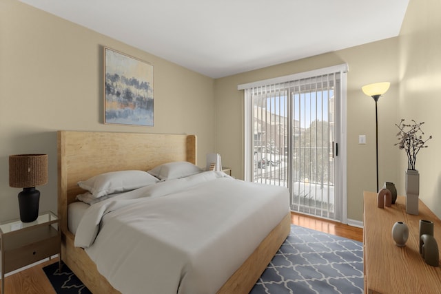 bedroom featuring hardwood / wood-style floors and access to exterior