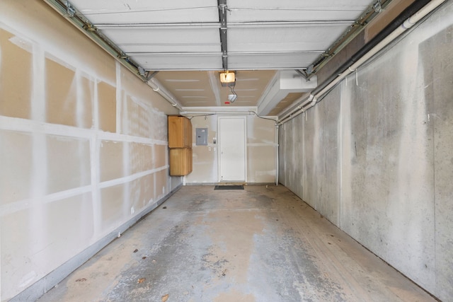 garage featuring electric panel and a garage door opener