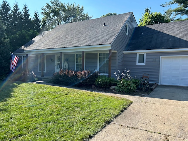 view of front facade with a garage, a front lawn, and covered porch