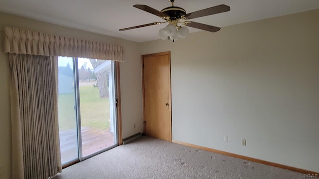 carpeted spare room with ceiling fan