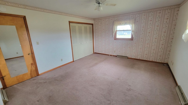 unfurnished bedroom with carpet flooring, a closet, ceiling fan, and crown molding