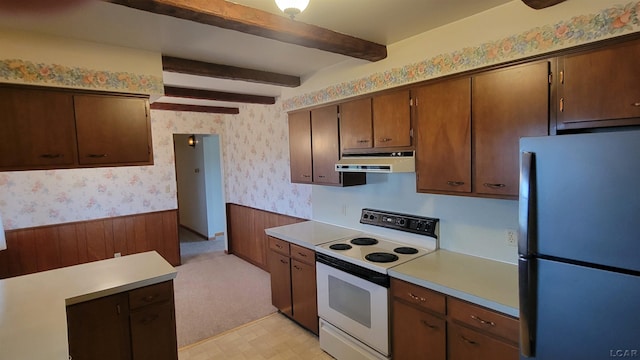 kitchen featuring electric range, stainless steel fridge, and beamed ceiling