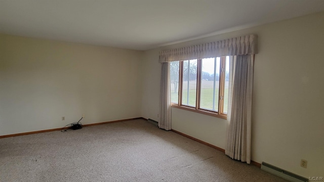 carpeted empty room featuring a baseboard radiator