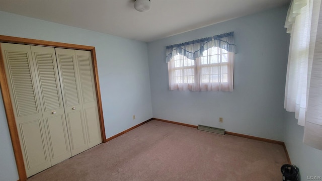 unfurnished bedroom with light carpet and a closet