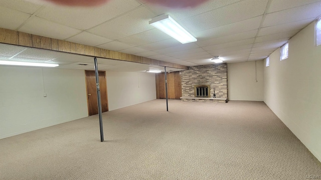 basement featuring a fireplace and light colored carpet