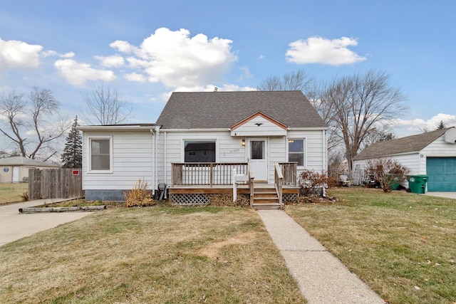 bungalow with a deck and a front lawn