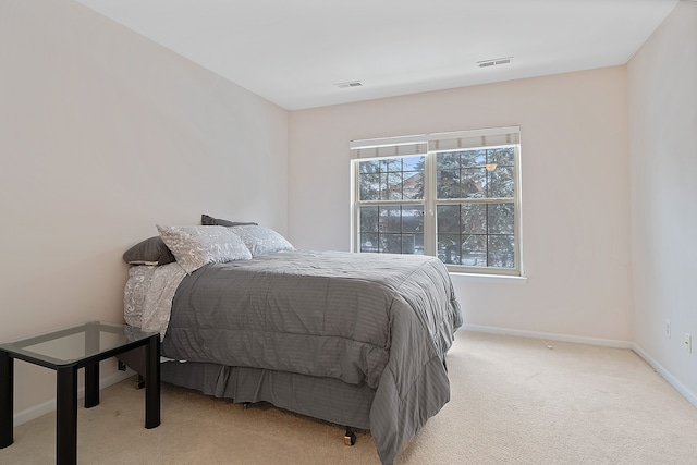 bedroom with light colored carpet