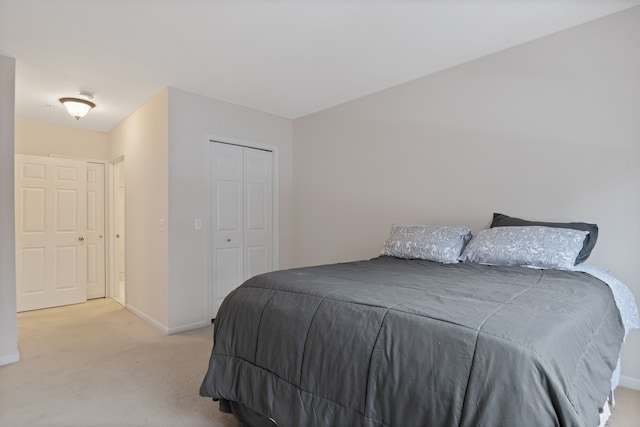 bedroom with light carpet and a closet