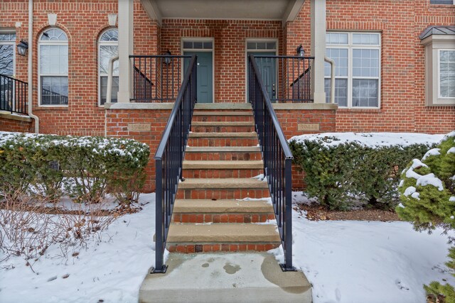 view of snow covered property entrance