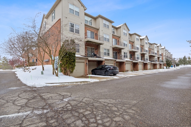 snow covered property featuring a garage