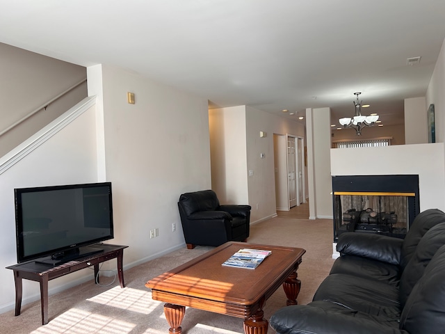 carpeted living room featuring an inviting chandelier and a multi sided fireplace