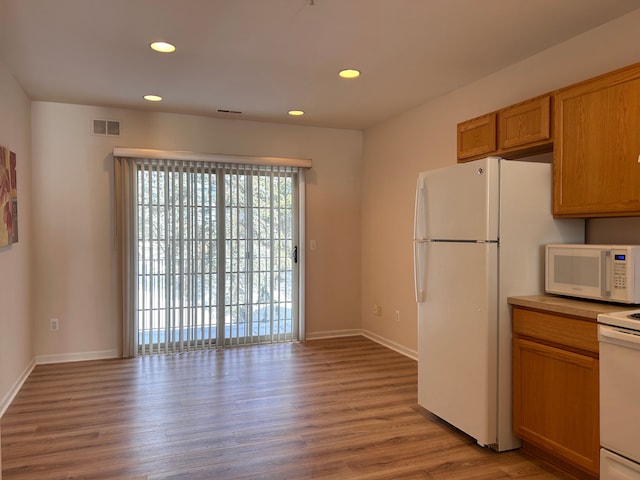 kitchen featuring white appliances and light wood-type flooring