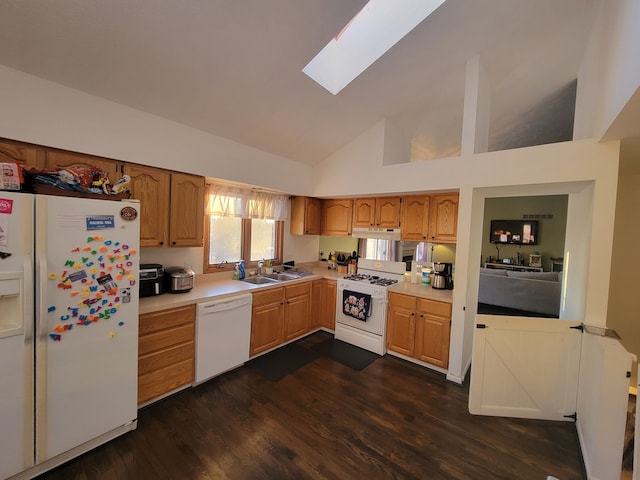 kitchen with white appliances, high vaulted ceiling, sink, a skylight, and dark hardwood / wood-style floors