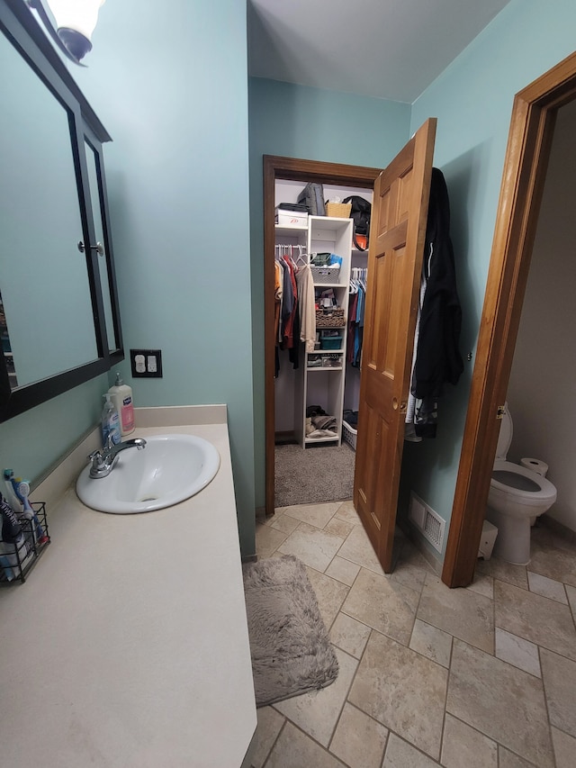 bathroom with vanity and toilet