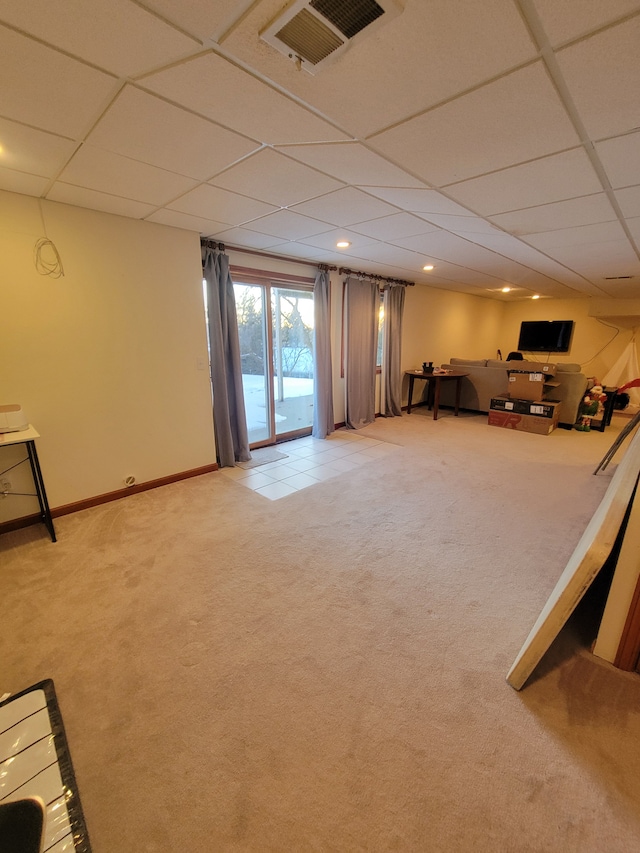 unfurnished living room featuring light colored carpet and a drop ceiling