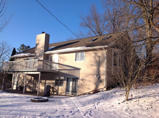 snow covered property featuring a deck