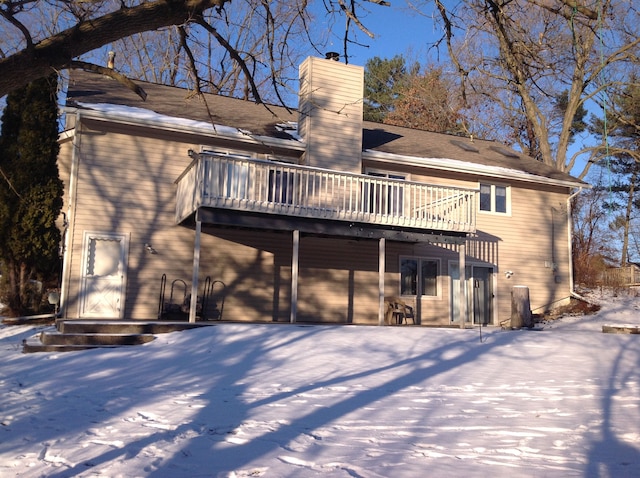 snow covered property with a deck