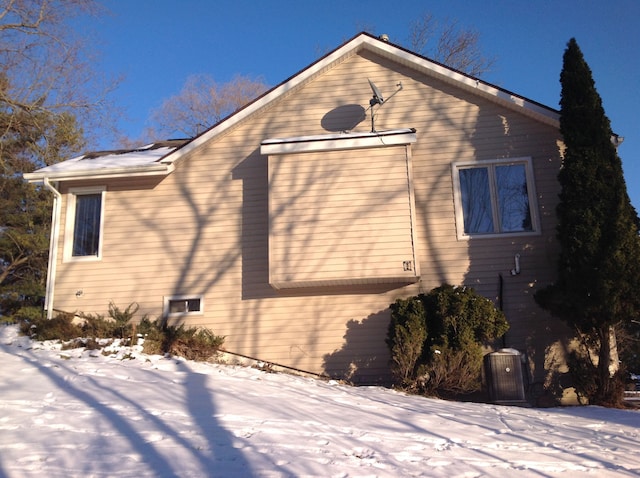 view of snow covered exterior featuring central air condition unit